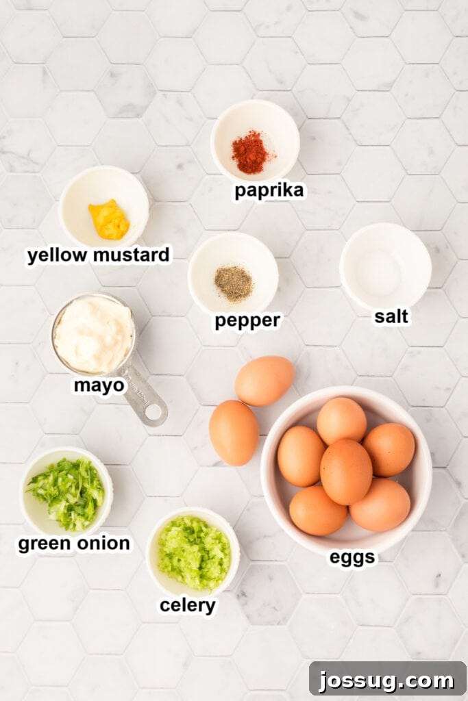 A flat lay image displaying the fresh ingredients required to make classic egg salad.