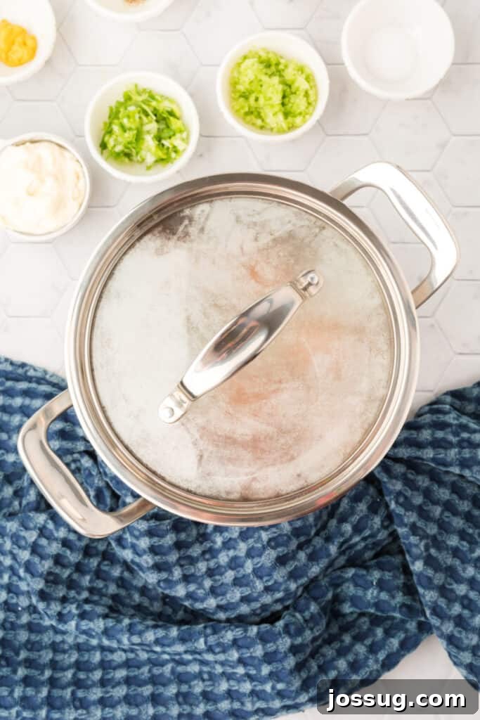 Step 2 of hard-boiling eggs: Bring water to a boil, then cover and remove from heat to let stand for 15 minutes.