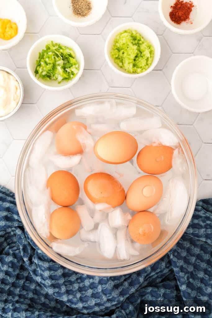 Step 3 of hard-boiling eggs: Transfer eggs to an ice water bath to cool completely.