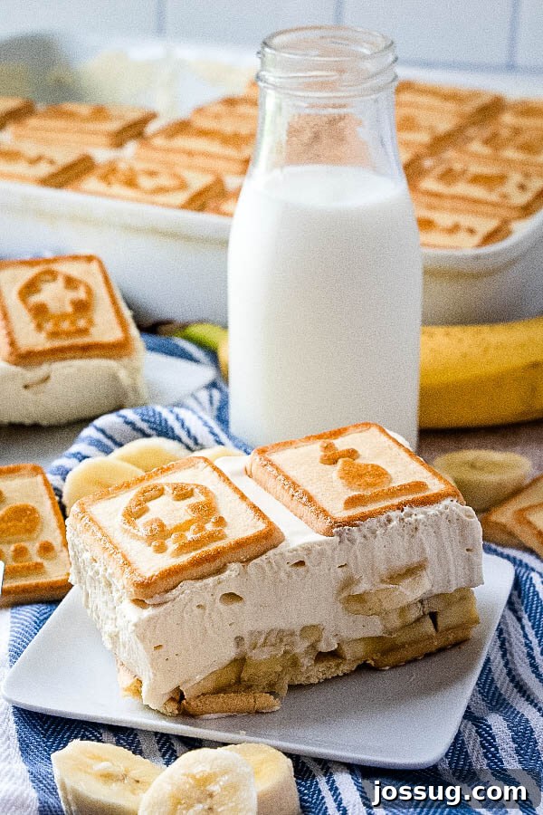 banana pudding on plate with glass of milk and dessert pan in background