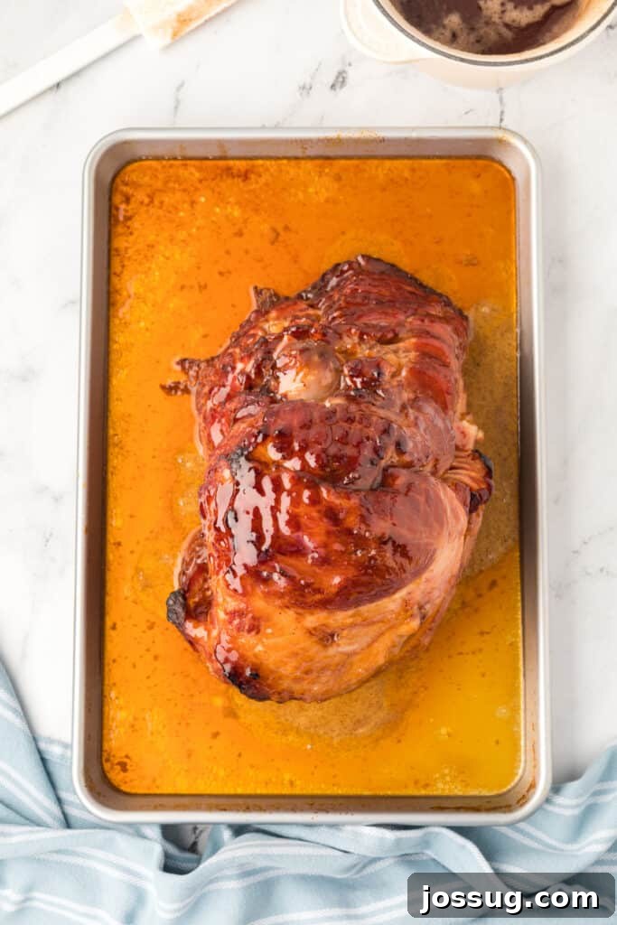 Carefully pour half of the glaze over the ham. Place the ham, uncovered, under the broiler. Watch it closely and broil for 1-2 minutes or until the glaze starts to bubble.