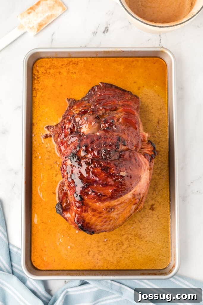 Remove the ham from the oven and pour the remaining glaze over the ham. Return the ham to the oven, uncovered, and continue to broil for 1-2 minutes.
