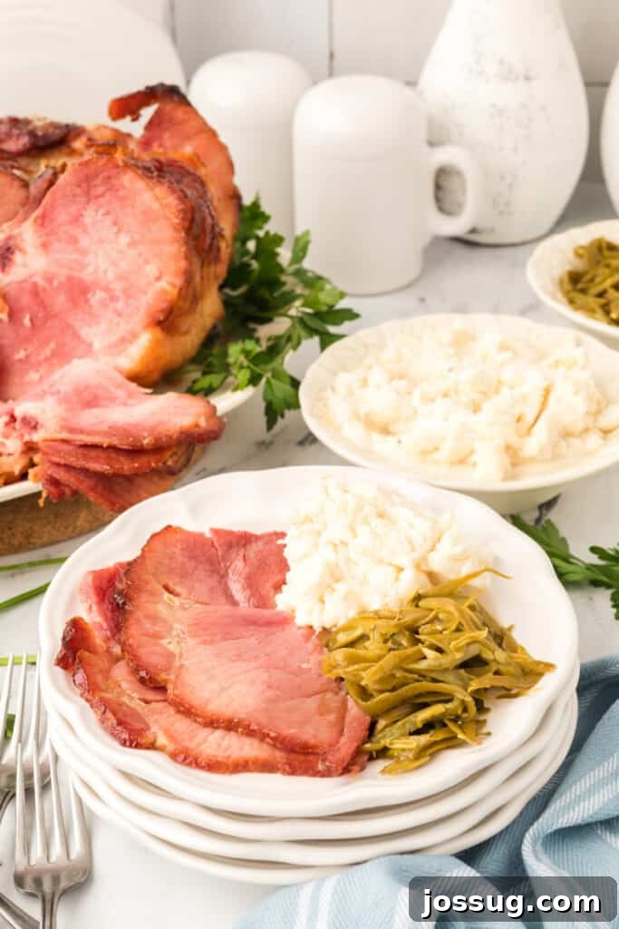 Glazed ham on a plate with side dishes, ready to be served