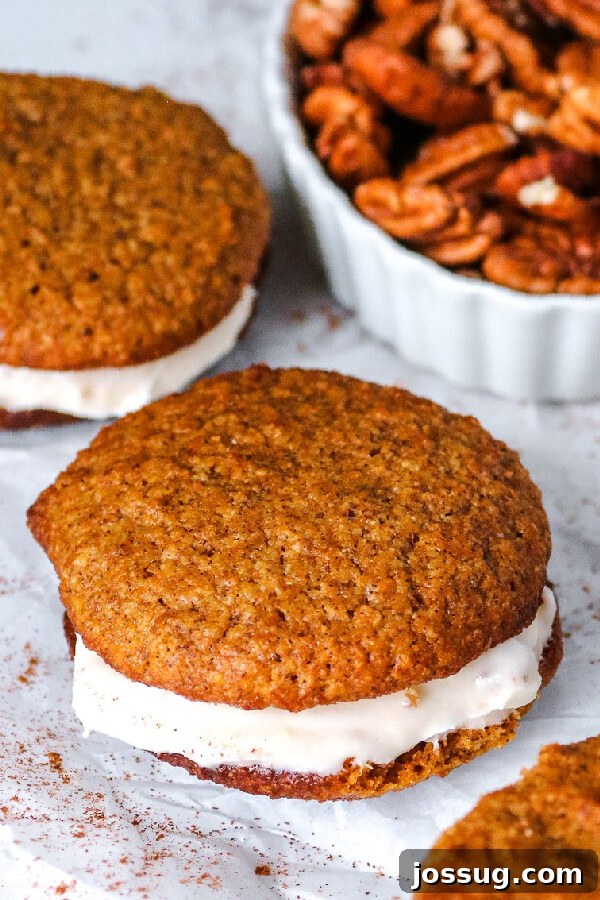 Pumpkin Spice Keto Whoopie Pies 5 Finished Keto Pumpkin Whoopie Pies with cream cheese pecan filling and a bowl of fresh pecans.