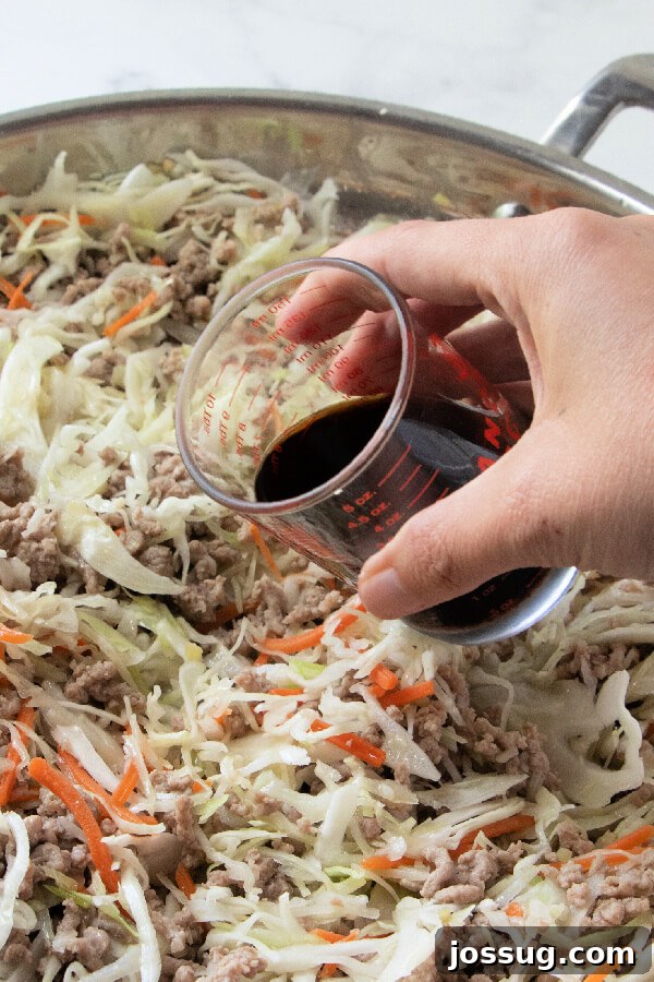 Adding Soy Sauce to Egg Roll in a Bowl Adding low-sodium soy sauce to the skillet during the cooking process.