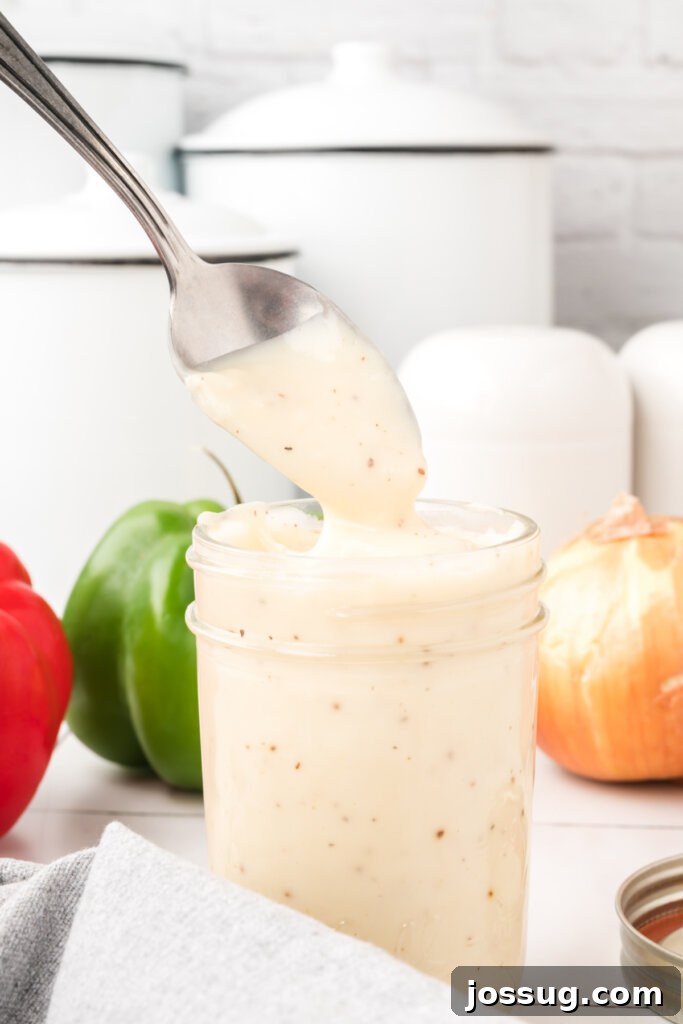 Homemade Condensed Cream Soup Substitute in a clear glass jar, ready for use in various recipes.
