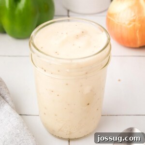 Homemade cream of mushroom soup in a glass jar, showing its creamy texture.