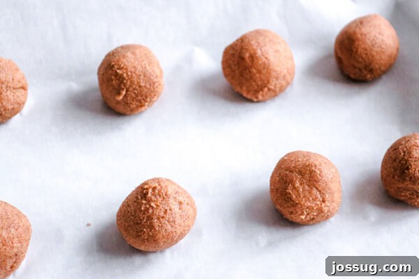 Pumpkin Pie Keto Bites 6 The cream cheese mixture neatly rolled into 8 individual balls on a parchment-lined sheet pan.