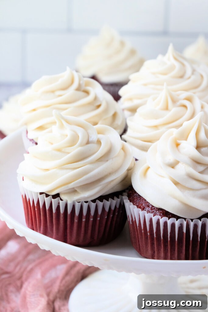 Irresistible Cream Cheese Swirl 6 frosted cupcakes on cake stand
