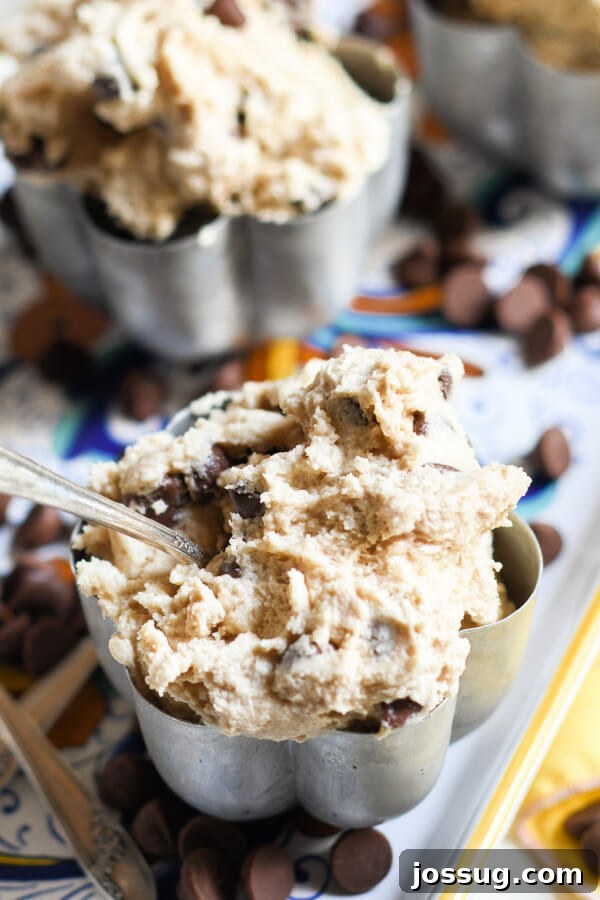 Scoop of Edible Chocolate Chip Cookie Dough in a metal bowl with a spoon on the side