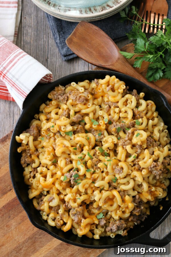 One-Pot Cheesy Beef Mac 2 Homemade Hamburger Helper in cast iron skillet, ready to serve.