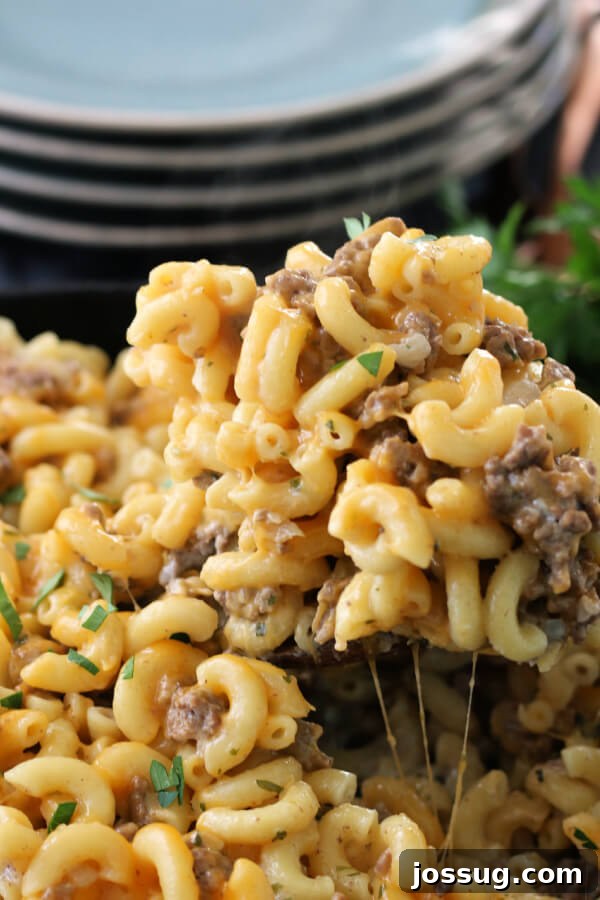 One-Pot Cheesy Beef Mac 8 A spoonful of homemade Hamburger Helper showing the creamy sauce, macaroni, and ground beef.