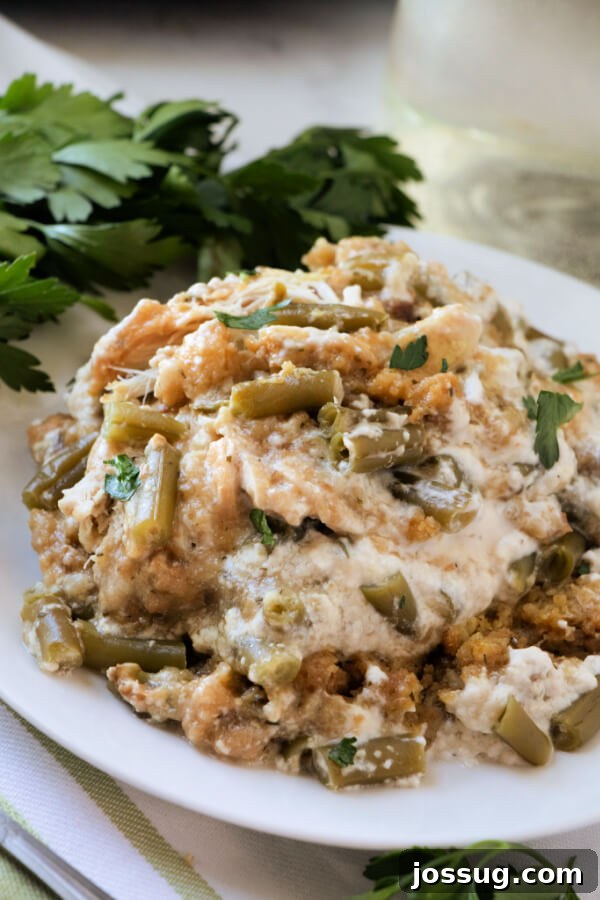 One-Pot Slow Cooker Chicken Stuffing Green Bean Dinner 2 Hearty Slow Cooker Chicken Stuffing Green Bean Casserole served on a white plate, ready to enjoy