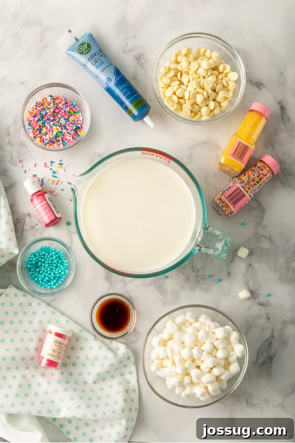 Rainbow Dream Cocoa 3 A delightful flat lay of ingredients laid out on a clean surface, ready to make unicorn hot chocolate, including milk, white chocolate chips, food coloring, whipped cream, sprinkles, and marshmallows.