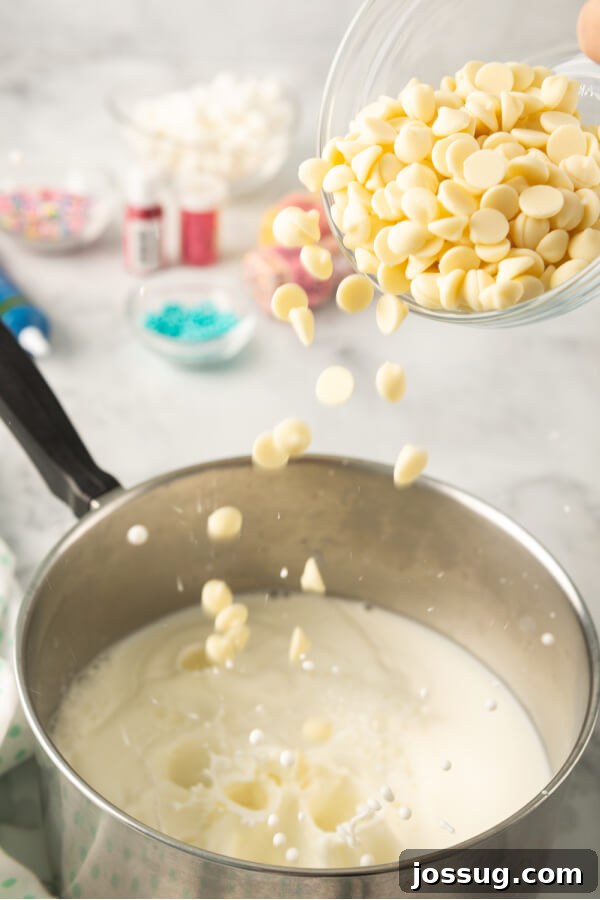 Rainbow Dream Cocoa 5 Adding white chocolate chips to a saucepan of milk, a crucial step for the creamy base of unicorn hot chocolate.