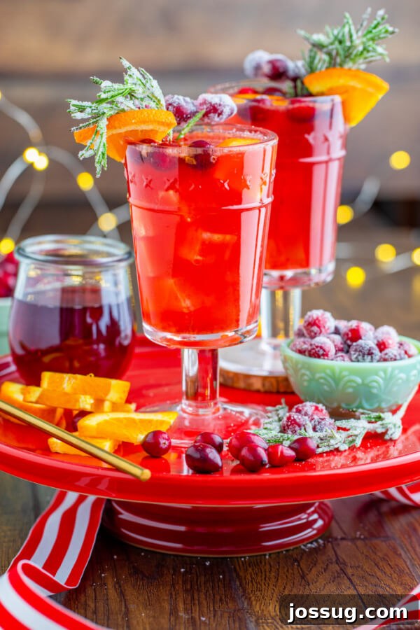 Christmas mocktail drinks served on a red cake stand with festive holiday decorations