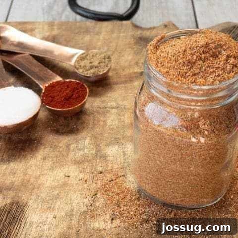 Keto Sweet Heat BBQ Spice Rub in a measuring cup, showcasing its texture.