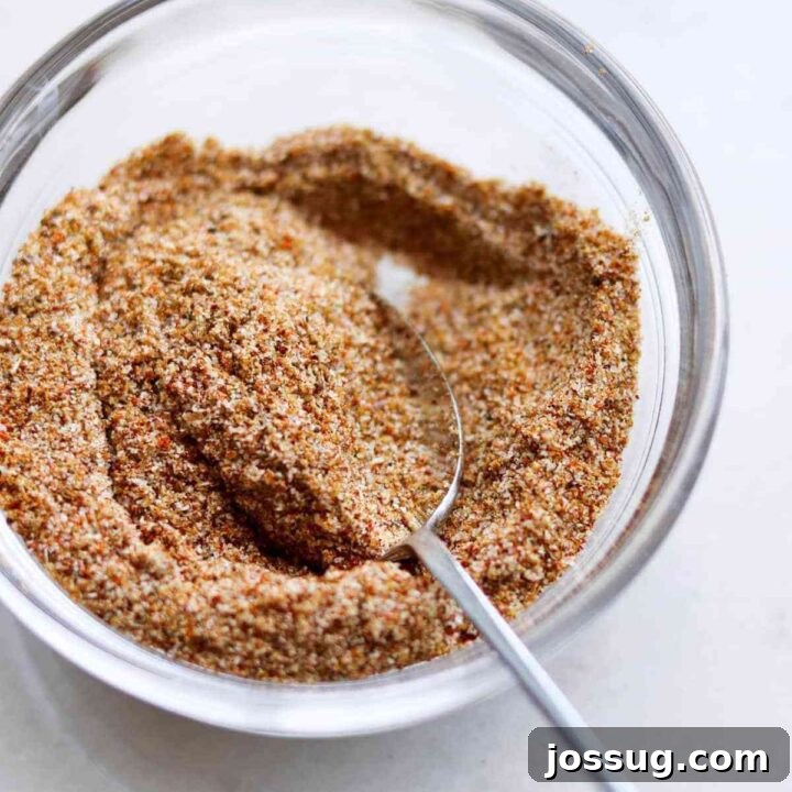 Blackened Seasoning (Keto, Whole30, Sugar Free) mix in a bowl with fresh herbs.