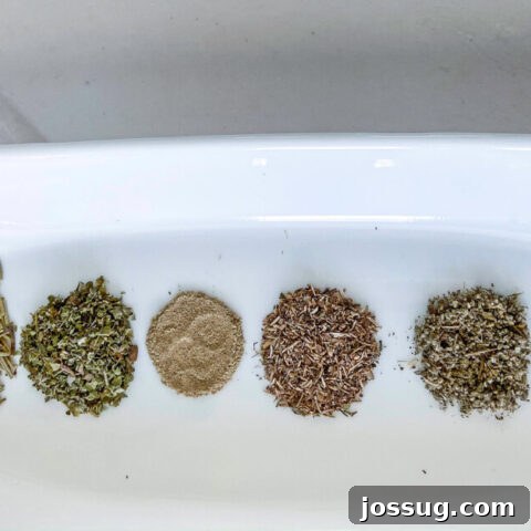 Homemade Poultry Seasoning in a small bowl with a serving spoon.