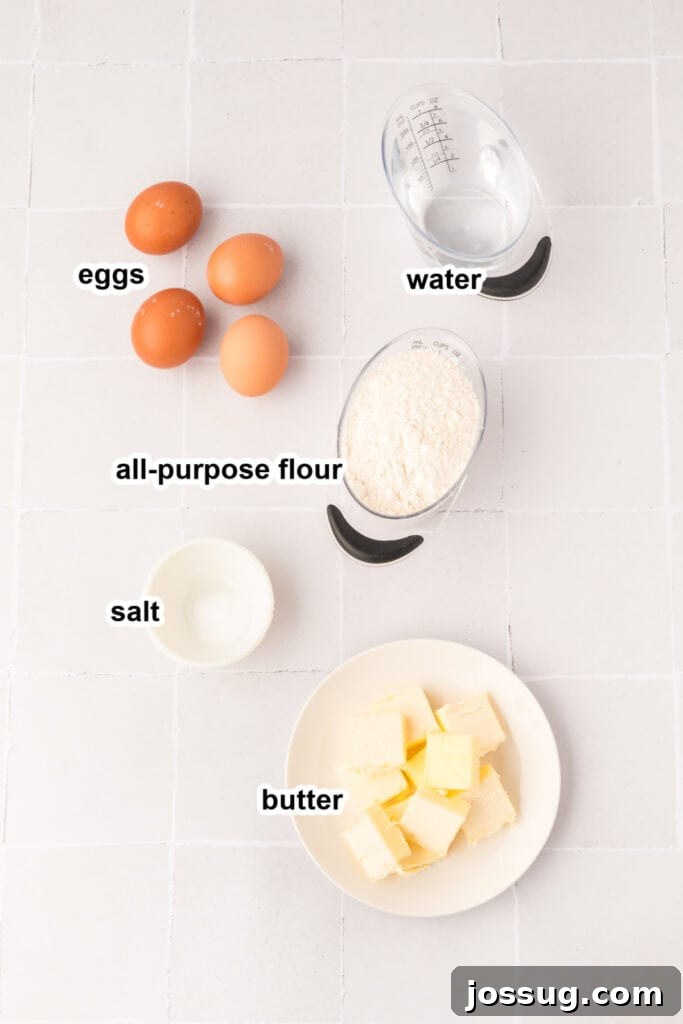 Pillowy Cream Dreams 3 Ingredients for the pastry shell laid out on a clean surface, including butter, flour, eggs, and salt.