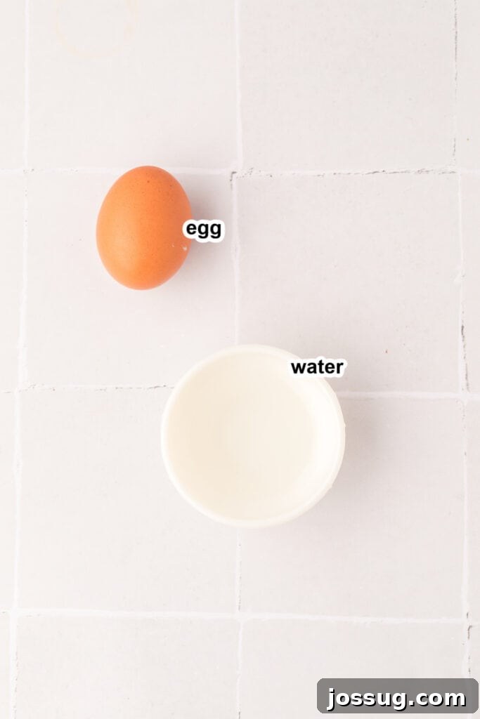 Pillowy Cream Dreams 4 A small bowl containing an egg and a splash of water, the simple components for the egg wash.