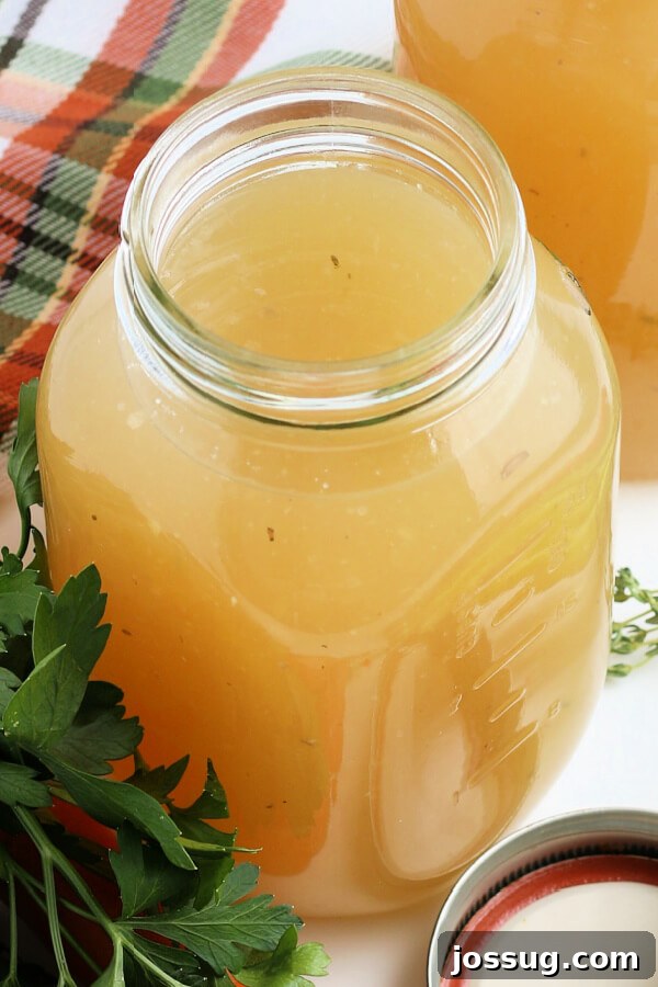 Rich Homemade Turkey Stock 2 Homemade turkey stock in a clear glass jar, ready for storage or use.
