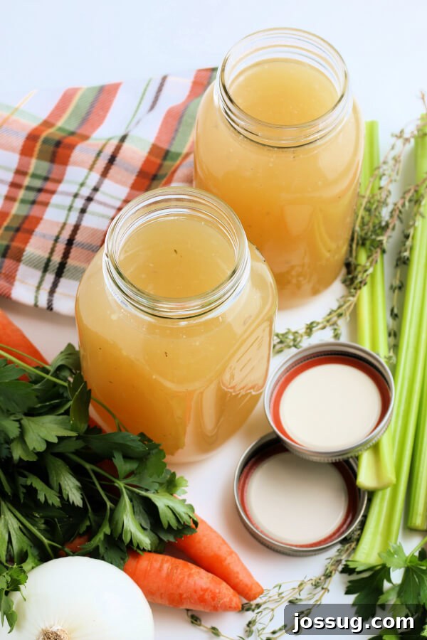 Rich Homemade Turkey Stock 7 Looking down into two elegant glass jars, one filled with golden turkey stock, emphasizing its clarity and richness.