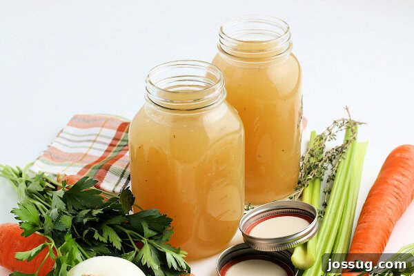 Rich Homemade Turkey Stock 9 Two jars of turkey stock beautifully arranged with fresh vegetables and herbs, inviting cooks to explore its potential.
