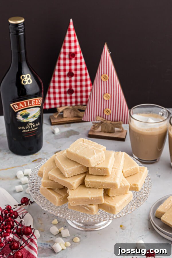 Decadent Baileys Irish Cream Fudge 8 Bailey's Irish Cream Fudge squares arranged in a holiday setting with ornaments and pinecones, emphasizing its seasonal appeal.