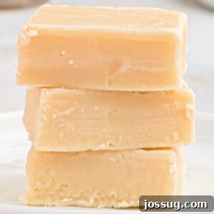 Three pieces of Bailey's Irish Cream Fudge stacked neatly, highlighting the smooth texture.