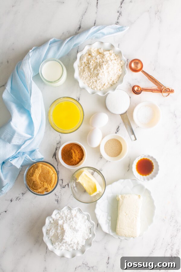 Ingredients laid out for making homemade cinnamon rolls, including flour, milk, eggs, butter, sugar, and yeast.