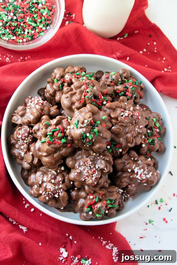 Crockpot Chocolate Treats 7 A festive bowl of slow cooker chocolate candies adorned with colorful Christmas sprinkles.
