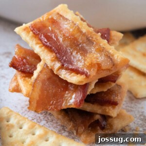 Closeup of bacon crackers stacked, showing the crispy texture and candied glaze for this easy sweet and savory appetizer.