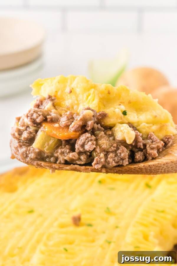 scoop of shepherds pie on wooden serving spoon