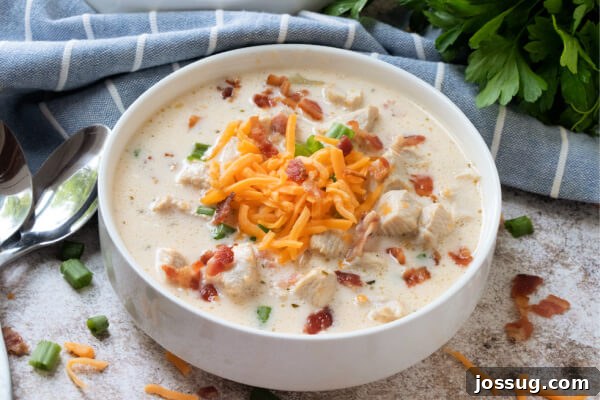 Creamy Chicken Bacon Ranch Delight 10 A final shot of the creamy crack chicken soup, served in a rustic bowl with a blue linen.