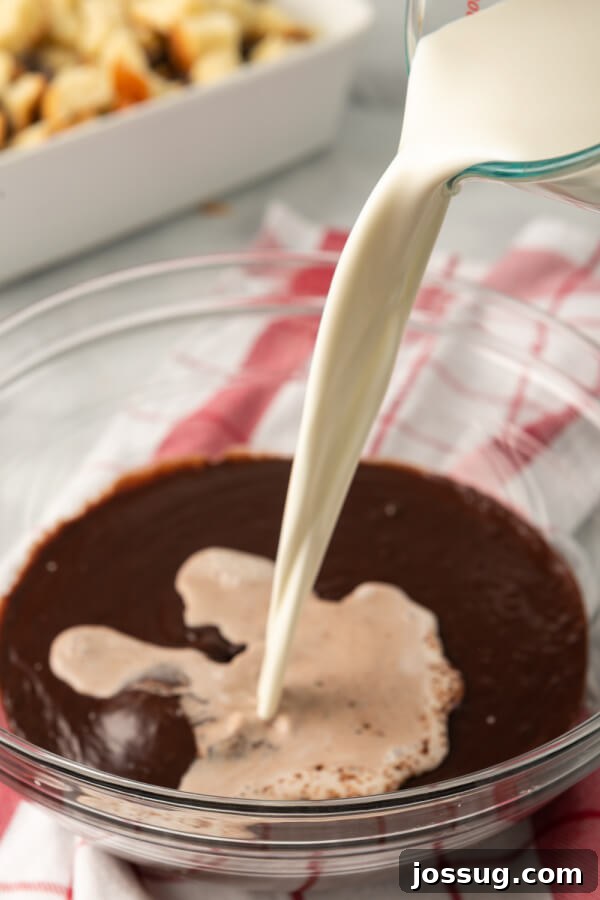 Decadent Chocolate Bread Pudding 6 The process of preparing the rich chocolate custard, with melted chocolate chips, cocoa powder, sugar, milk, eggs, vanilla, and salt being whisked together in a large bowl.