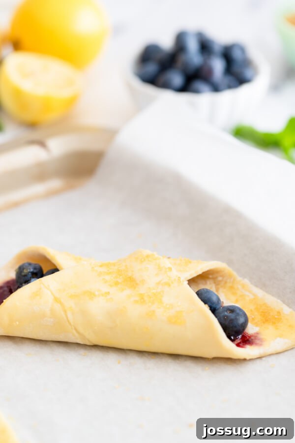 Bright Lemon Blueberry Danish Delight 8 Coarse sugar being sprinkled generously over the Danish pastries just before they are placed in the oven for baking