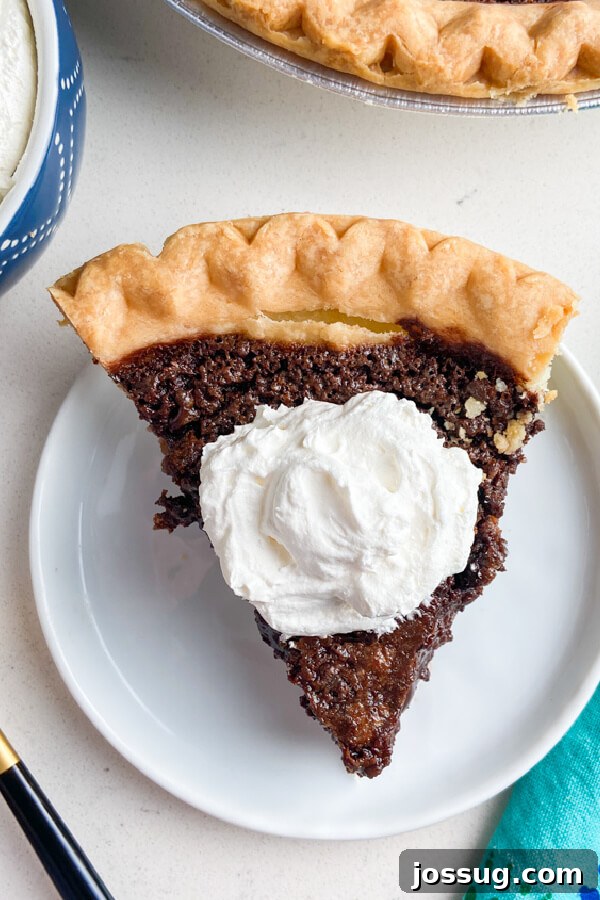Decadent Chocolate Chess Pie 7 looking down on a slice of chocolate chess pie with whipped cream on top