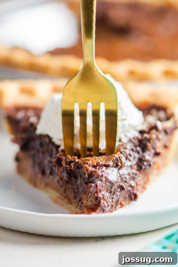 Decadent Chocolate Chess Pie 8 a fork taking off a bite of pie from the slice