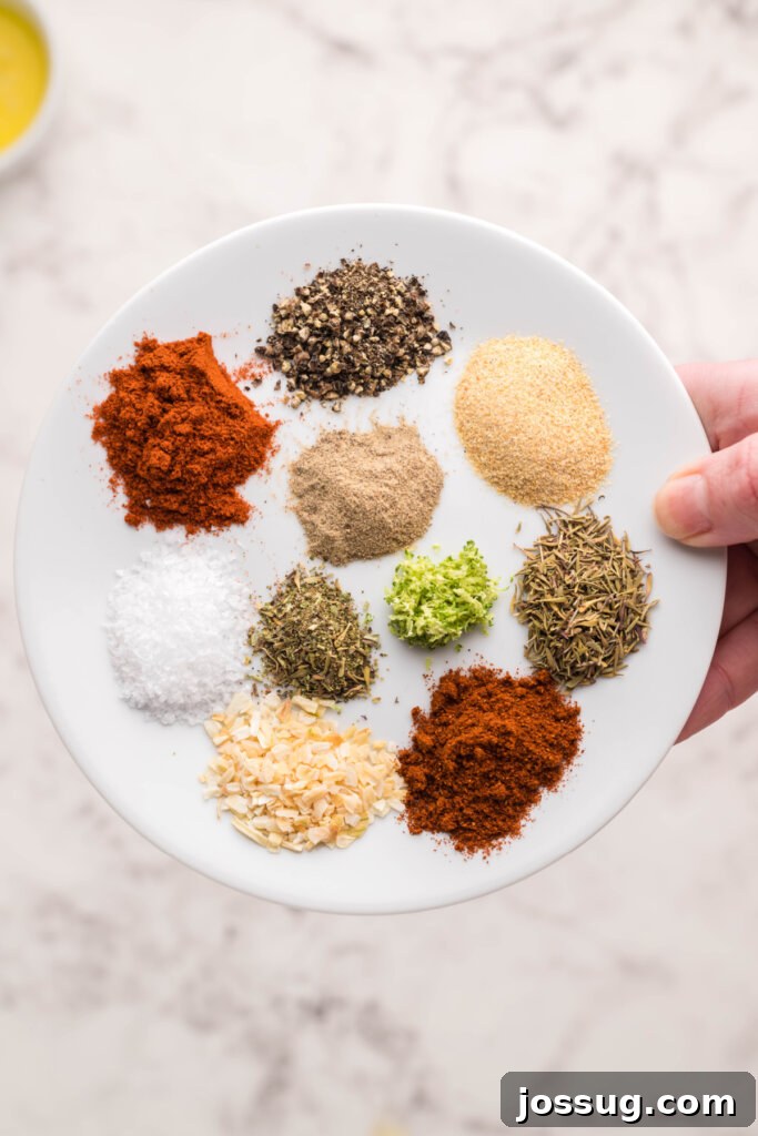 Cajun Blackened Seasoning 2 An array of vibrant spices and fresh herbs beautifully arranged on a rustic plate, ready to be blended into homemade blackened seasoning.