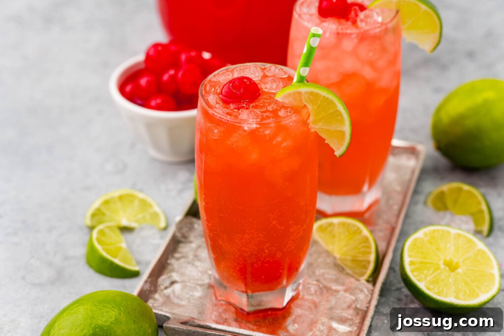 Homemade Sonic Cherry Limeade 5 A vibrant red cherry limeade drink in a glass with lime slices and cherries, showcasing its appeal as a refreshing beverage.