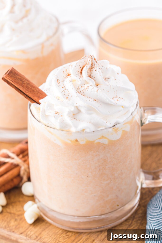 Velvet Pumpkin Spice Cocoa 2 clear glass of pumpkin spice white hot chocolate topped with whipped cream