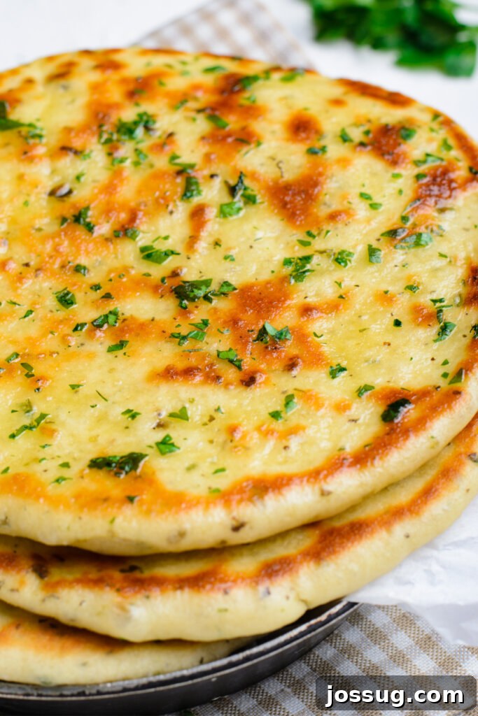 Handcrafted Dough Wonders 3 A perfectly stacked pile of golden brown, fluffy homemade flatbreads ready to be enjoyed.
