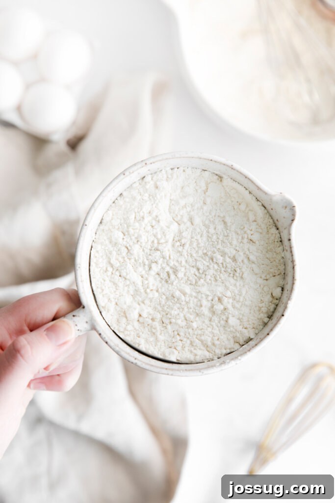 Making Cake Flour at Home 3 Hand holding a bowl of cake flour substitute