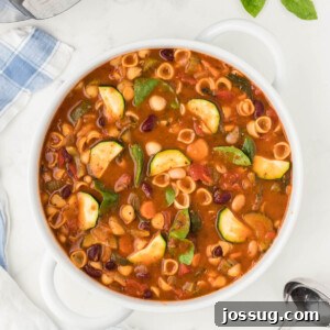 Minestrone soup in a white bowl, a vibrant and comforting dish.