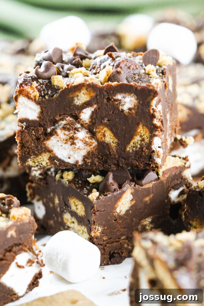 Two pieces of S'mores Fudge stacked on top of each other, showcasing the layers of chocolate, marshmallows, and graham crackers.