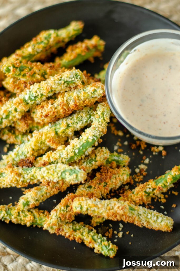 Crunchy Green Bean Frites 2 Black plate with perfectly golden green bean fries and a small bowl of creamy dipping sauce