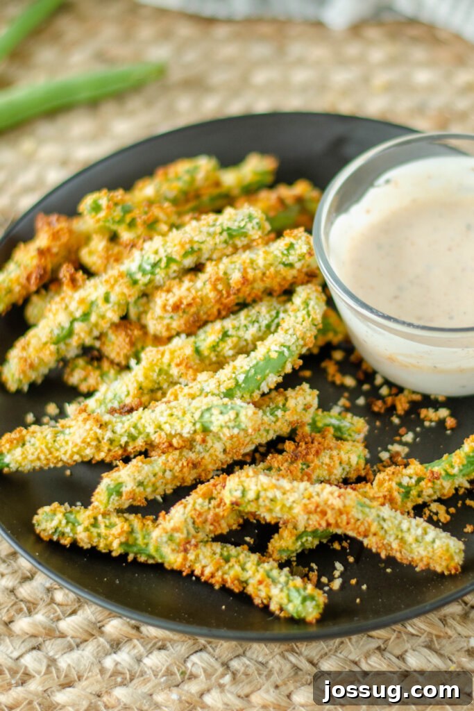 Crunchy Green Bean Frites 3 Plate piled high with golden green bean fries and a small ramekin of kicking ranch dipping sauce