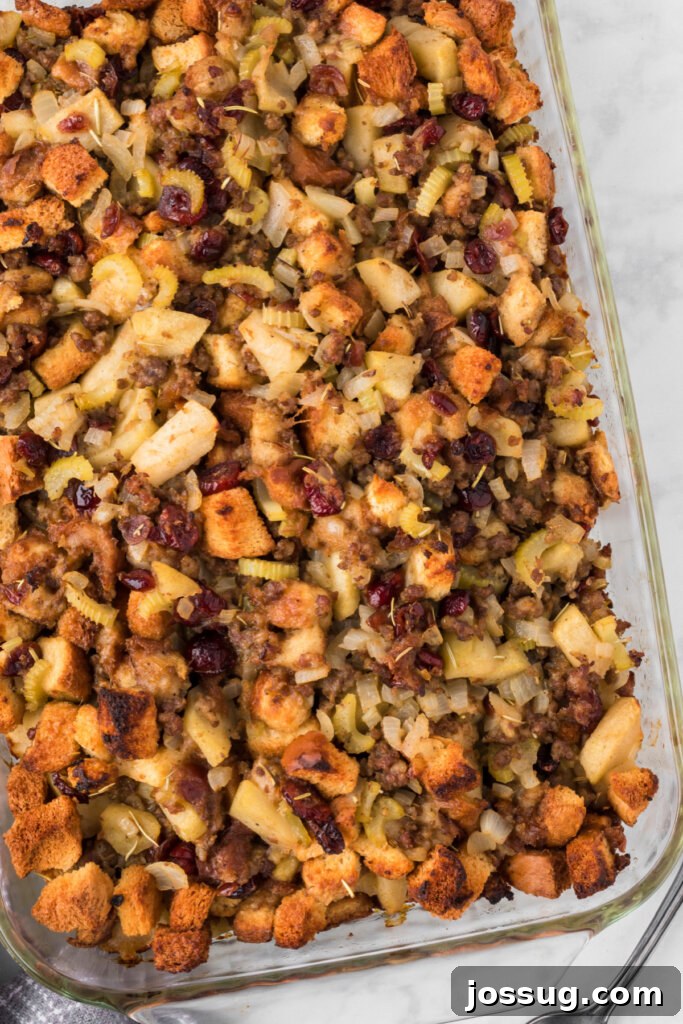 Delicious Cranberry Apple Sausage Stuffing in a baking dish, glistening and ready to be served.