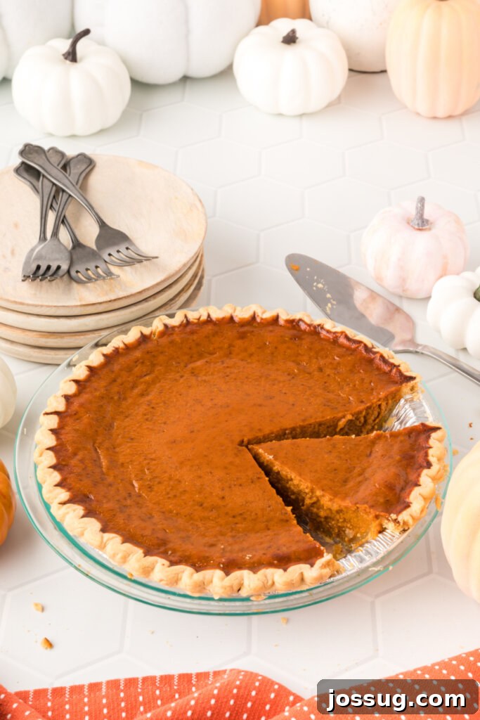 whole pumpkin pie with a slice cut